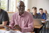 adults in a classroom sitting in their desks